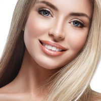 Beautiful woman blonde portrait face close up studio on white Healthy skin woman face looking camera with blond long hair